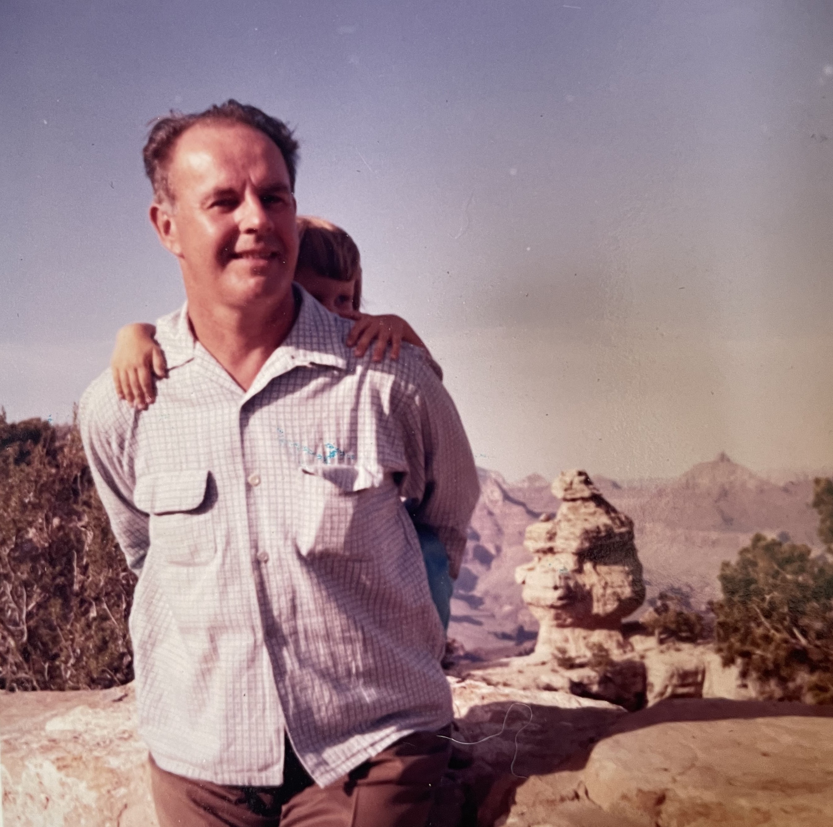 Dick Baltz carries his daughter Mary on his back